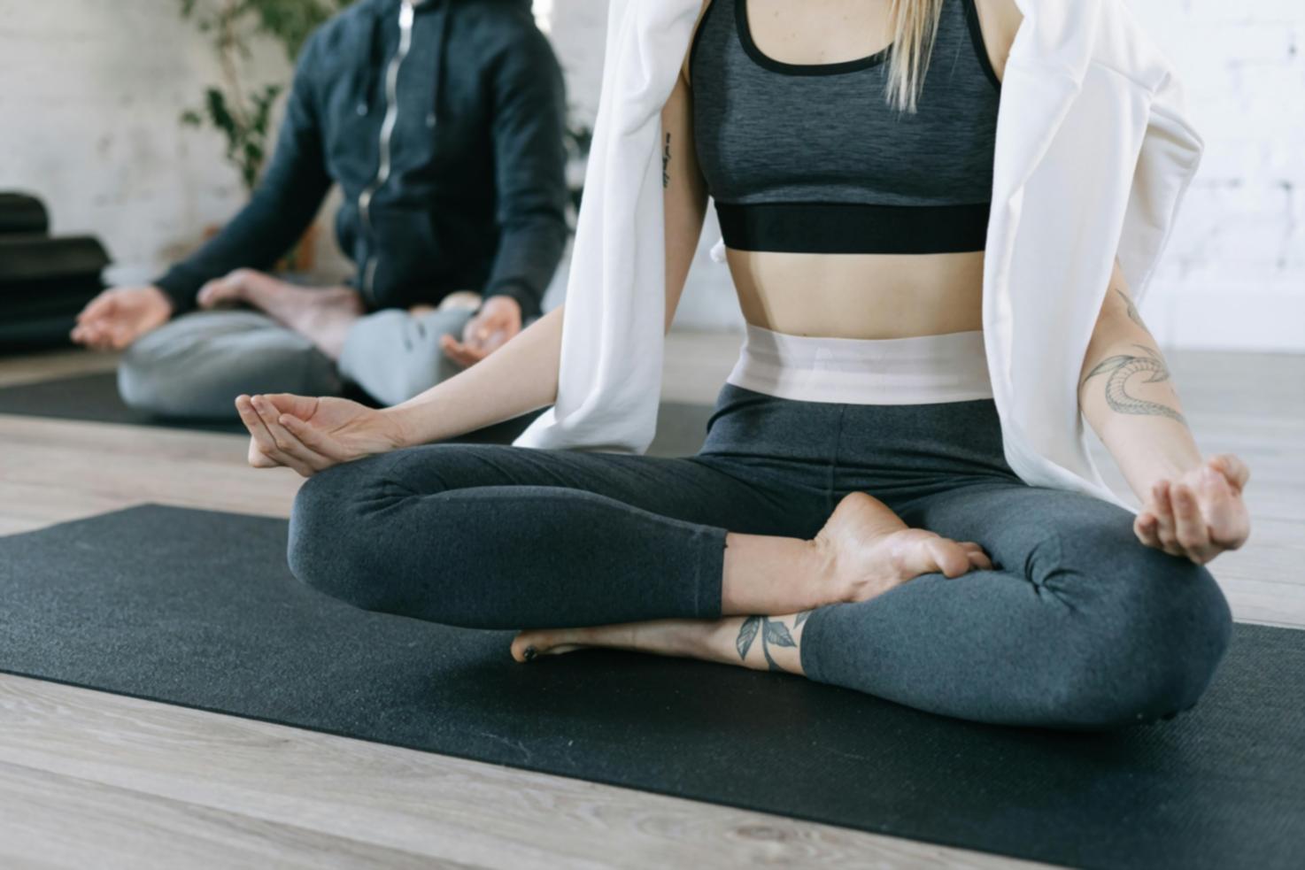 Person practicing yoga in peaceful morning light showing the real-world environment where consistent practice happens